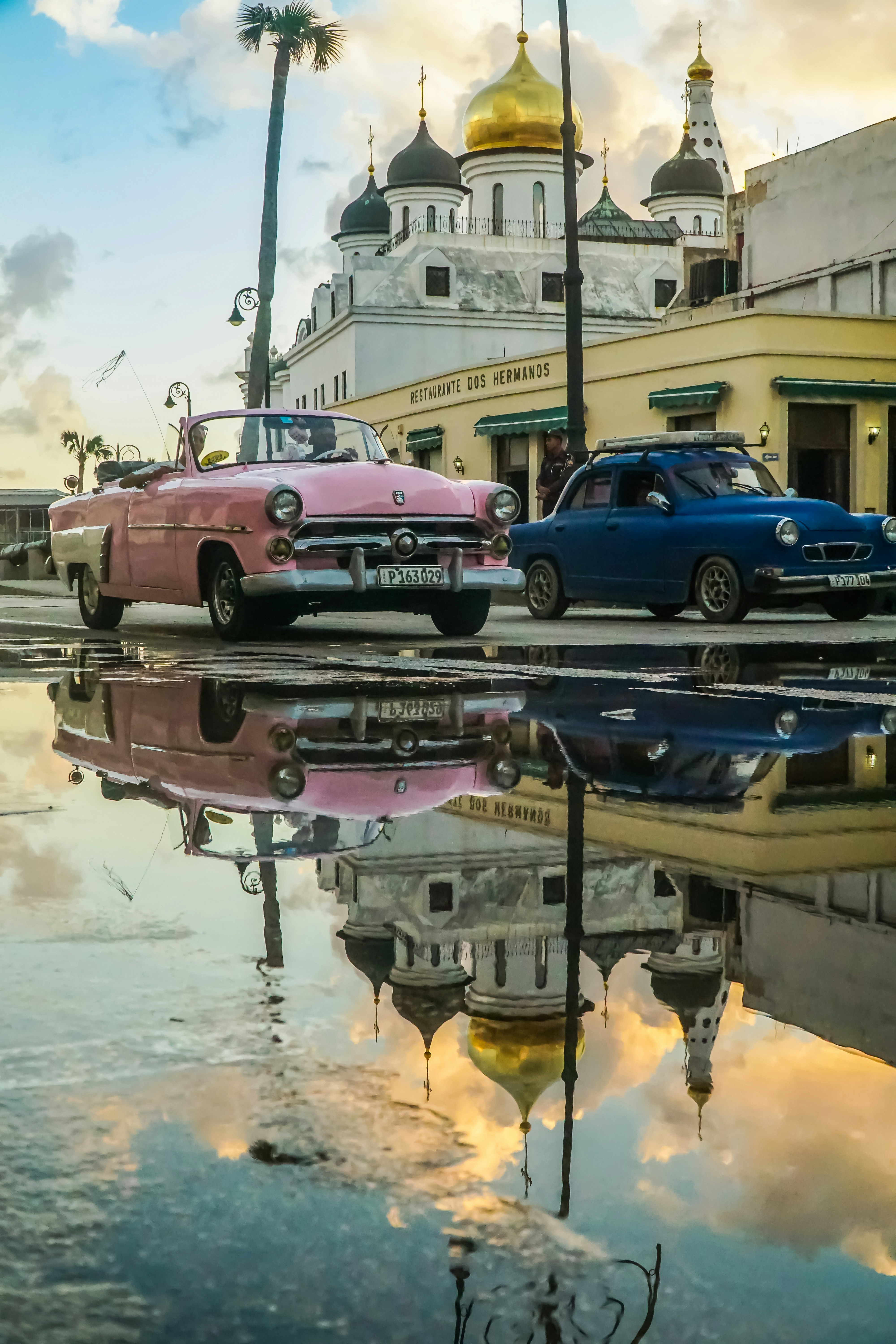 red and blue cars on road during daytime