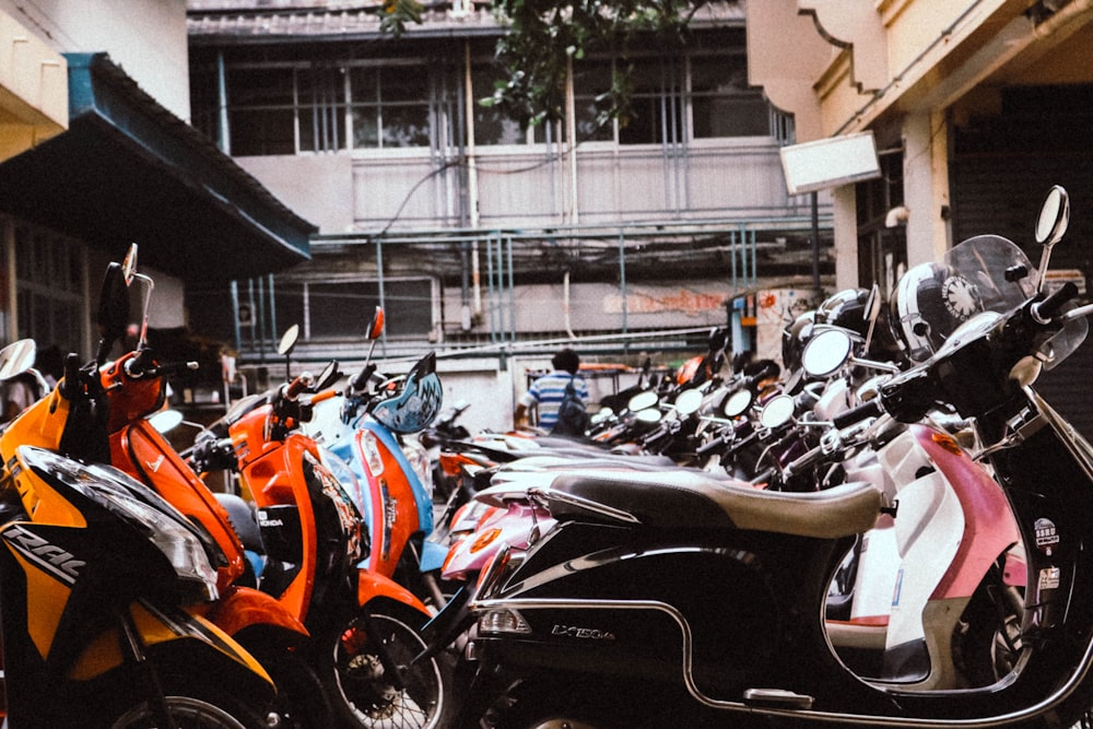 black and orange sports bike parked on parking lot