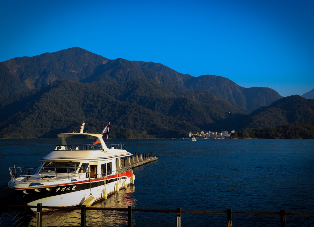 white and blue boat on sea dock during daytime