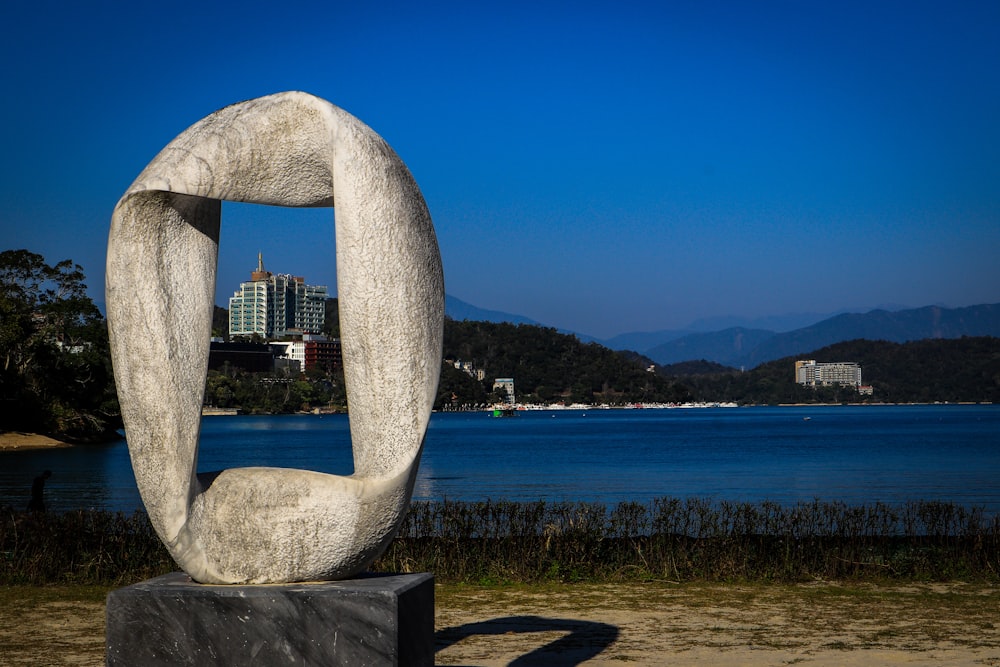 gray concrete arch near body of water during daytime