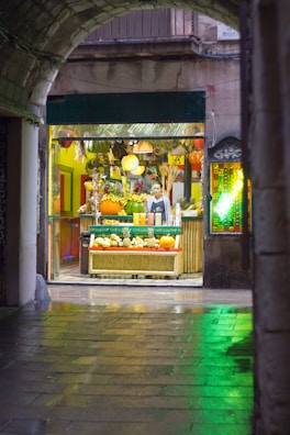 A lively market stall bursting with tropical fruits and handmade crafts, bathed in warm daylight.