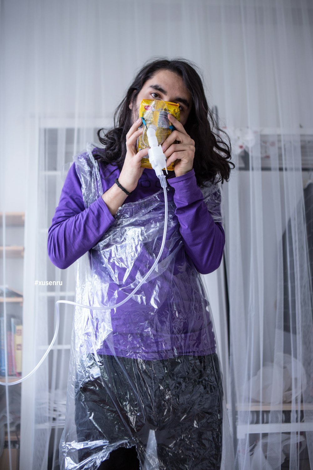 woman in purple long sleeve shirt holding yellow and green plastic cup