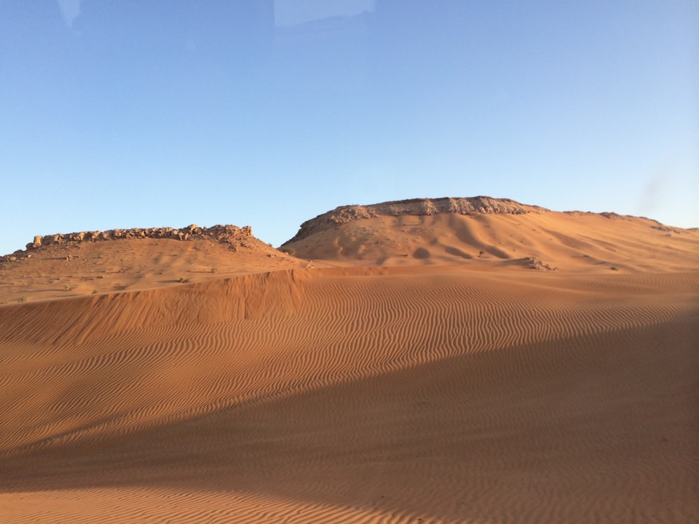 brown sand under blue sky during daytime