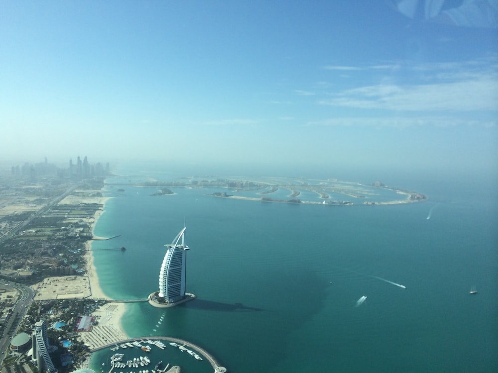 aerial view of white building near body of water during daytime