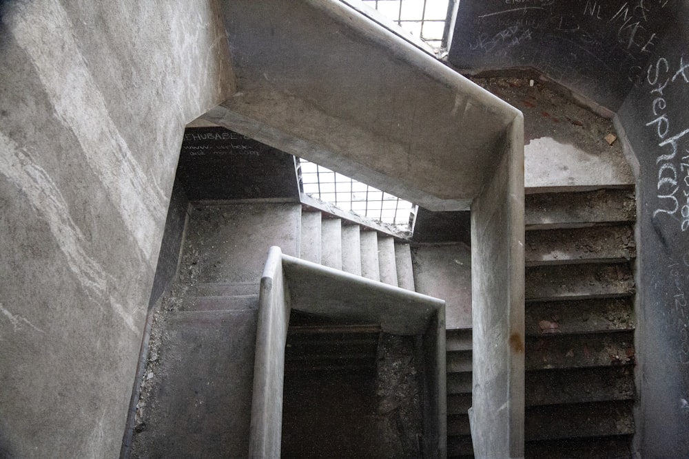 a stairwell with graffiti on the walls and steps