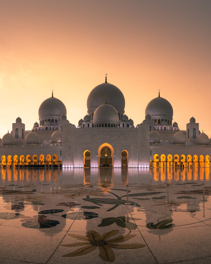 Sultan Mosque with its golden dome and grand entrance at golden hour