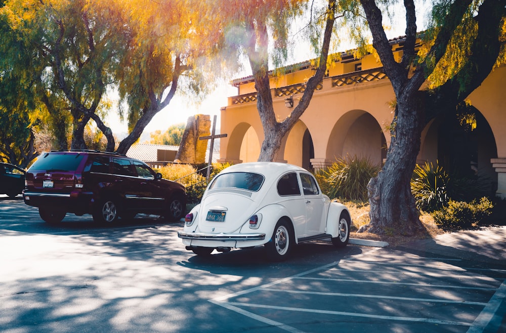 a white car parked in a parking lot next to a building