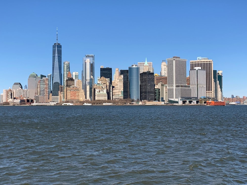 city skyline across body of water during daytime