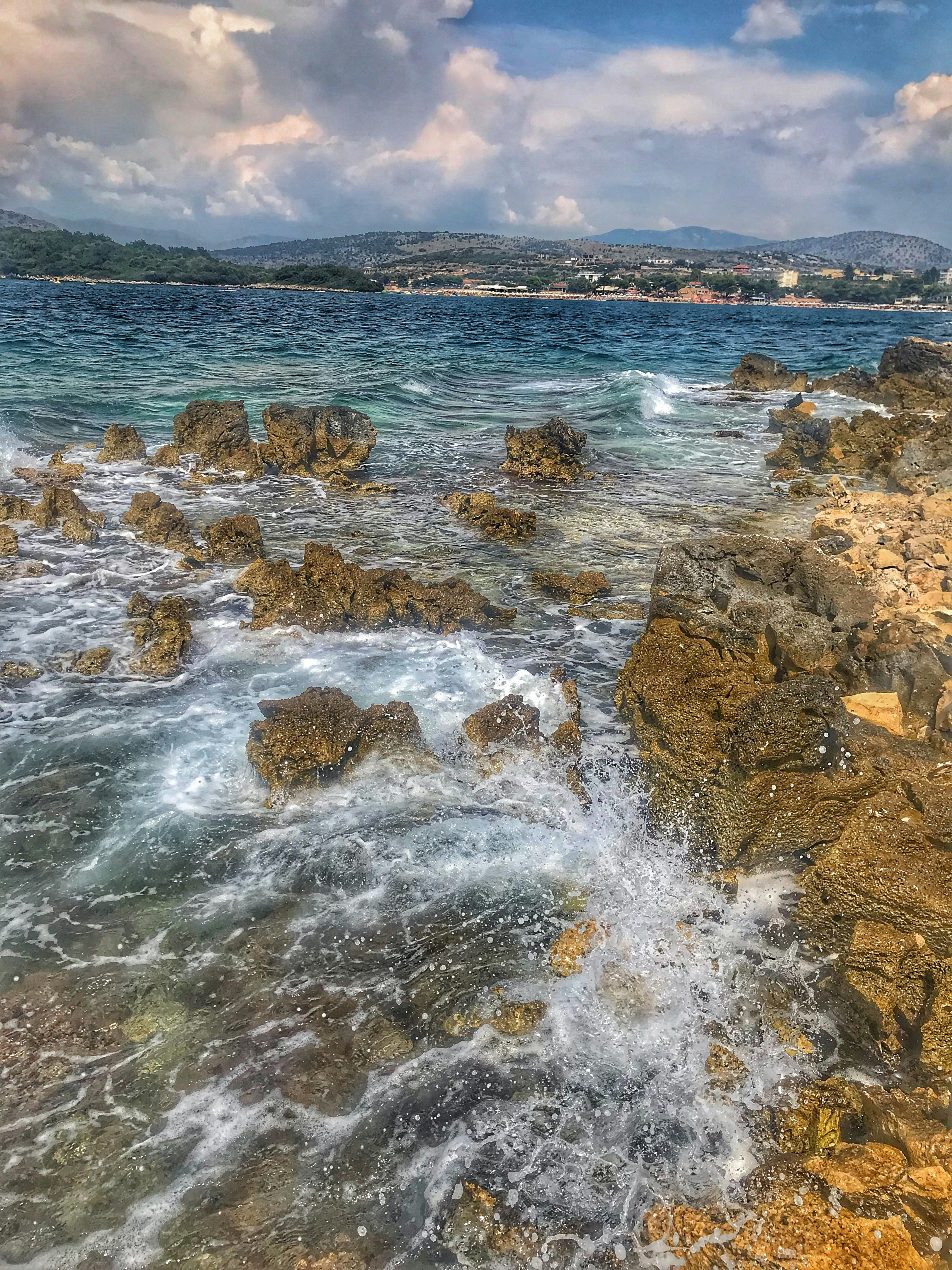 brown rock formation on sea during daytime