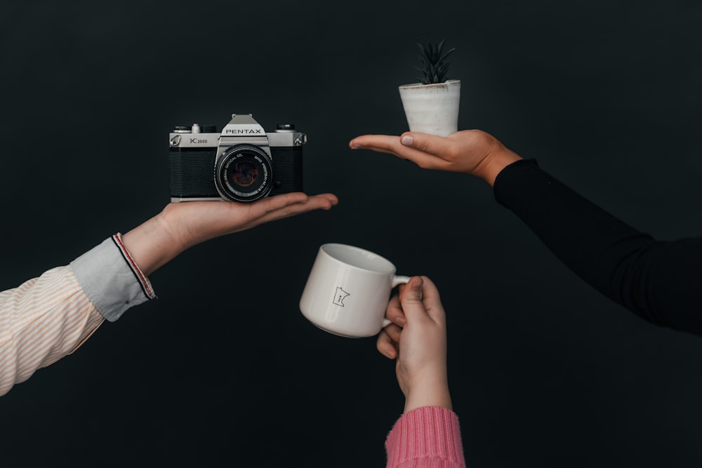 person holding white ceramic mug