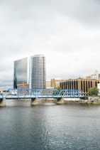 blue bridge over river near city buildings during daytime