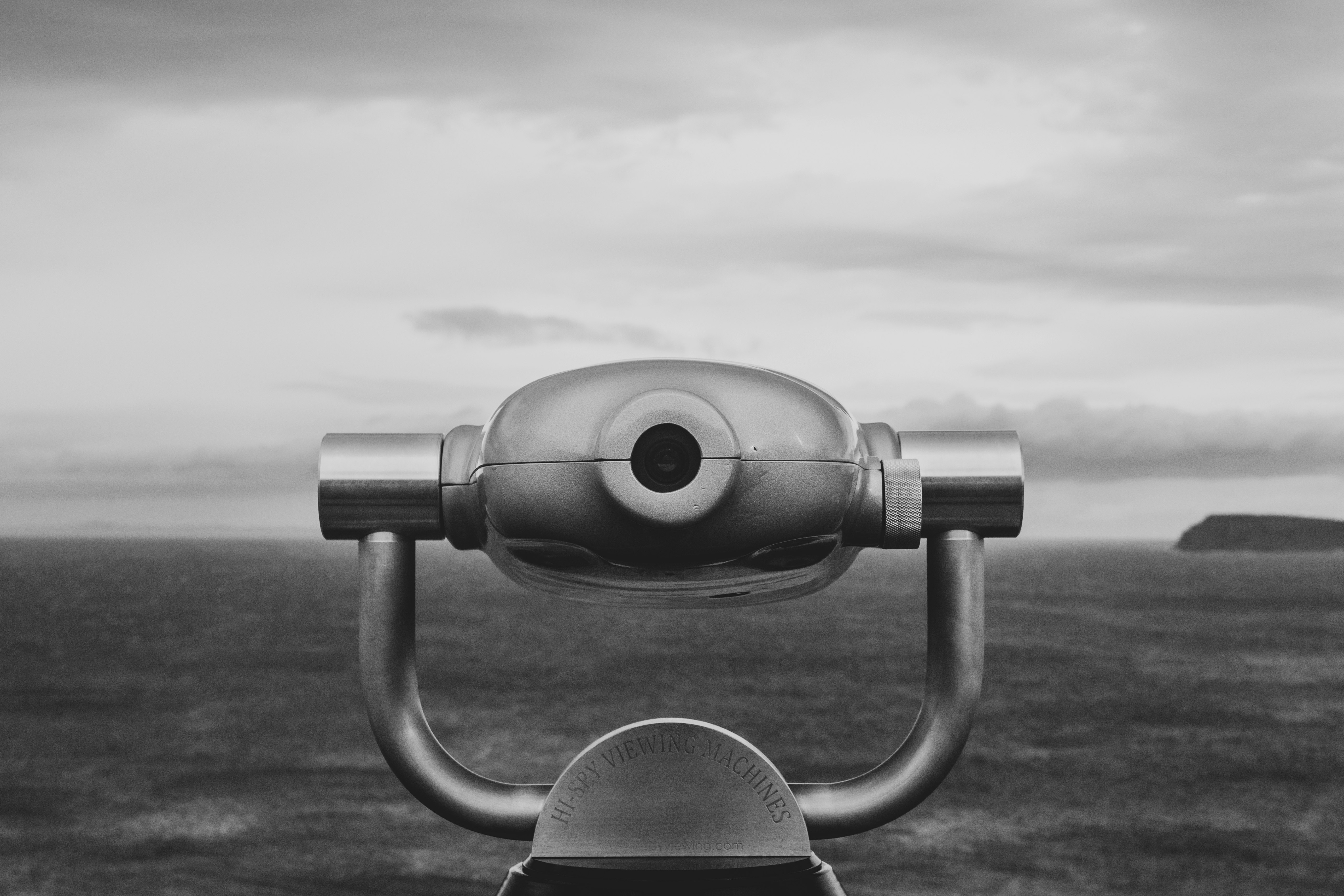 gray coin operated binoculars under cloudy sky during daytime