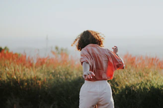 man in red and white hoodie carrying girl in white long sleeve shirt during daytime
