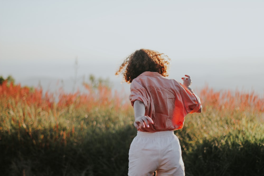 man in red and white hoodie carrying girl in white long sleeve shirt during daytime