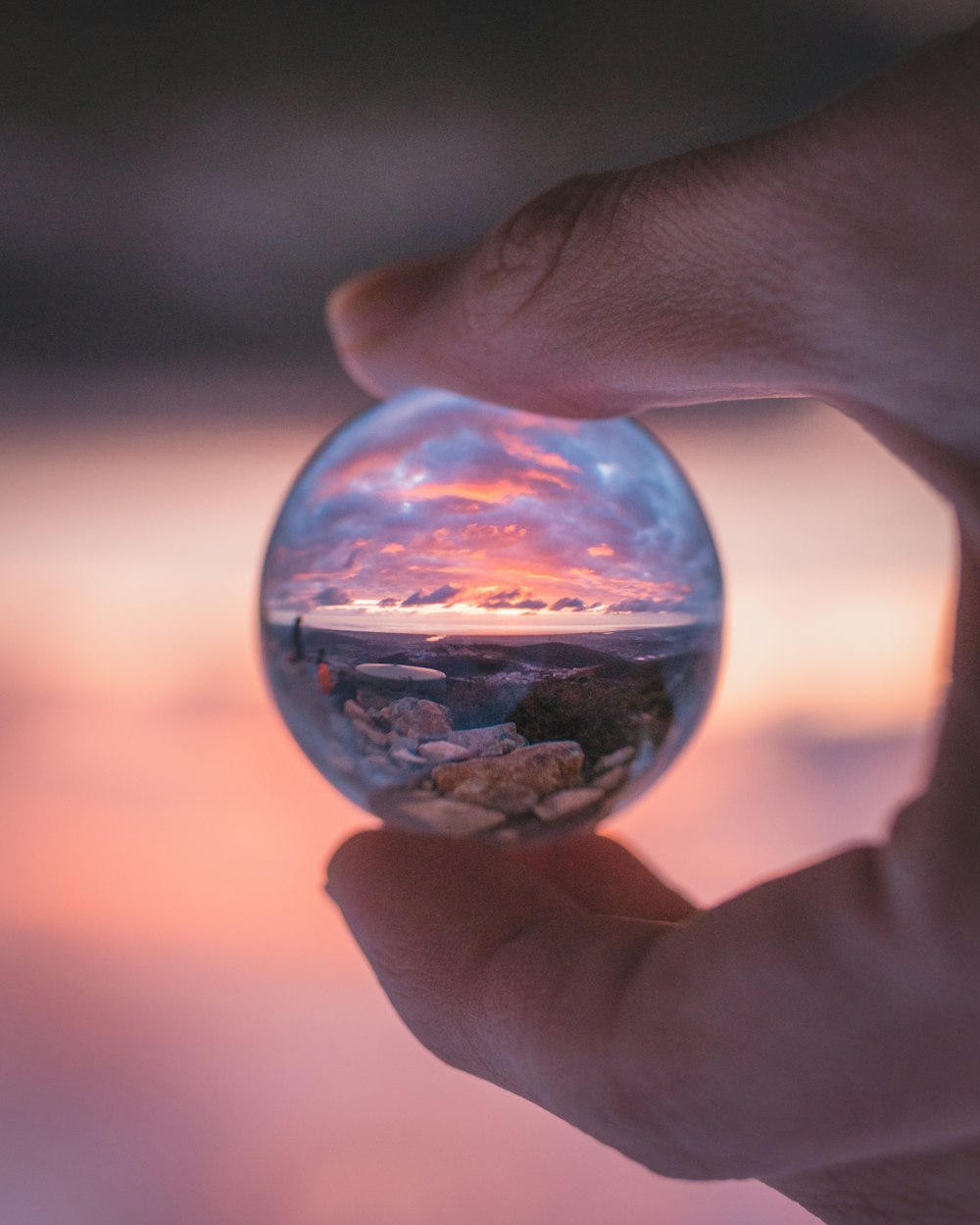 person holding clear glass ball