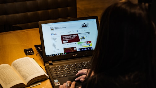person using black laptop computer