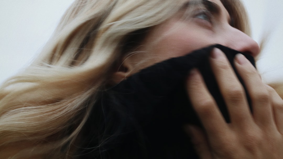woman covering her face with her hand
