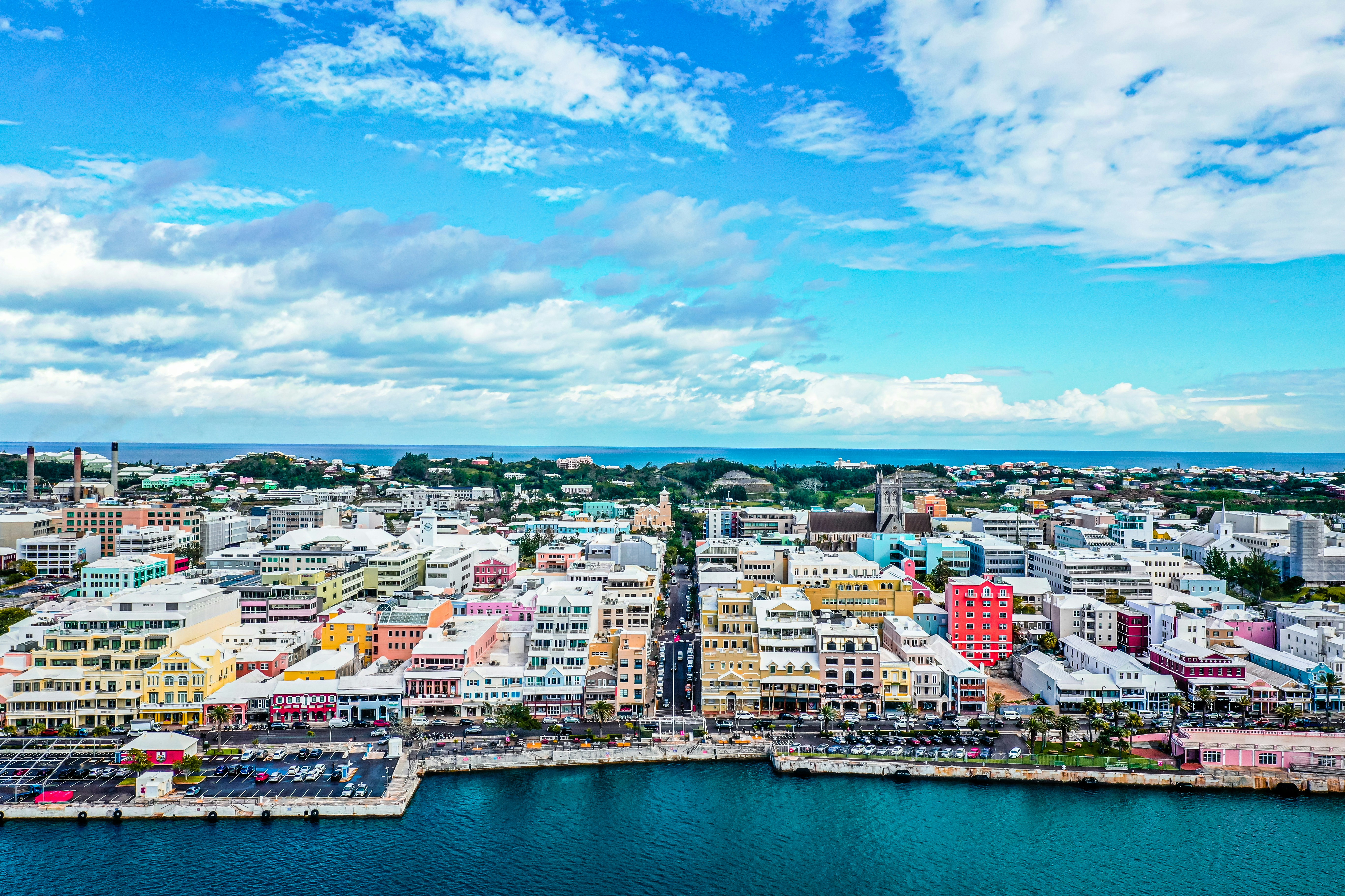 city buildings near body of water under blue sky during daytime