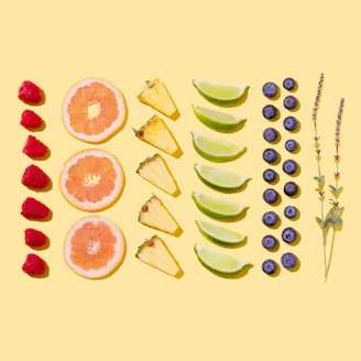 A vibrant assortment of fresh fruits and spices artfully arranged on a rustic wooden table.