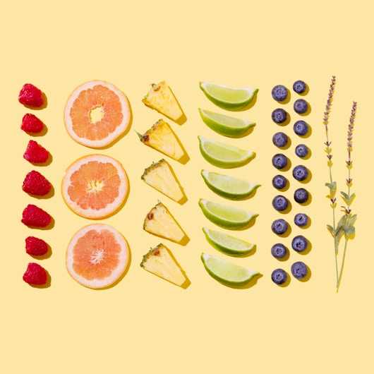 sliced fruits on white surface