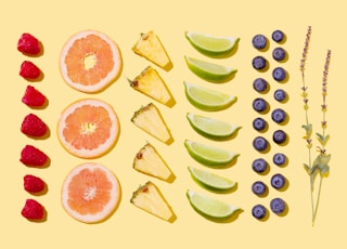 sliced fruits on white surface