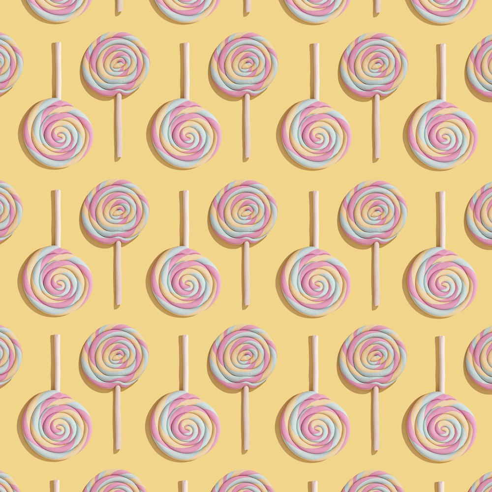 a pattern of lollipops on a yellow background