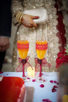 2 clear drinking glasses with yellow liquid