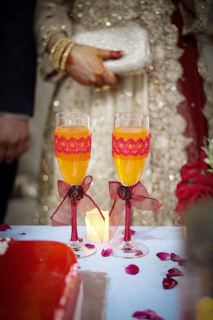 2 clear drinking glasses with yellow liquid