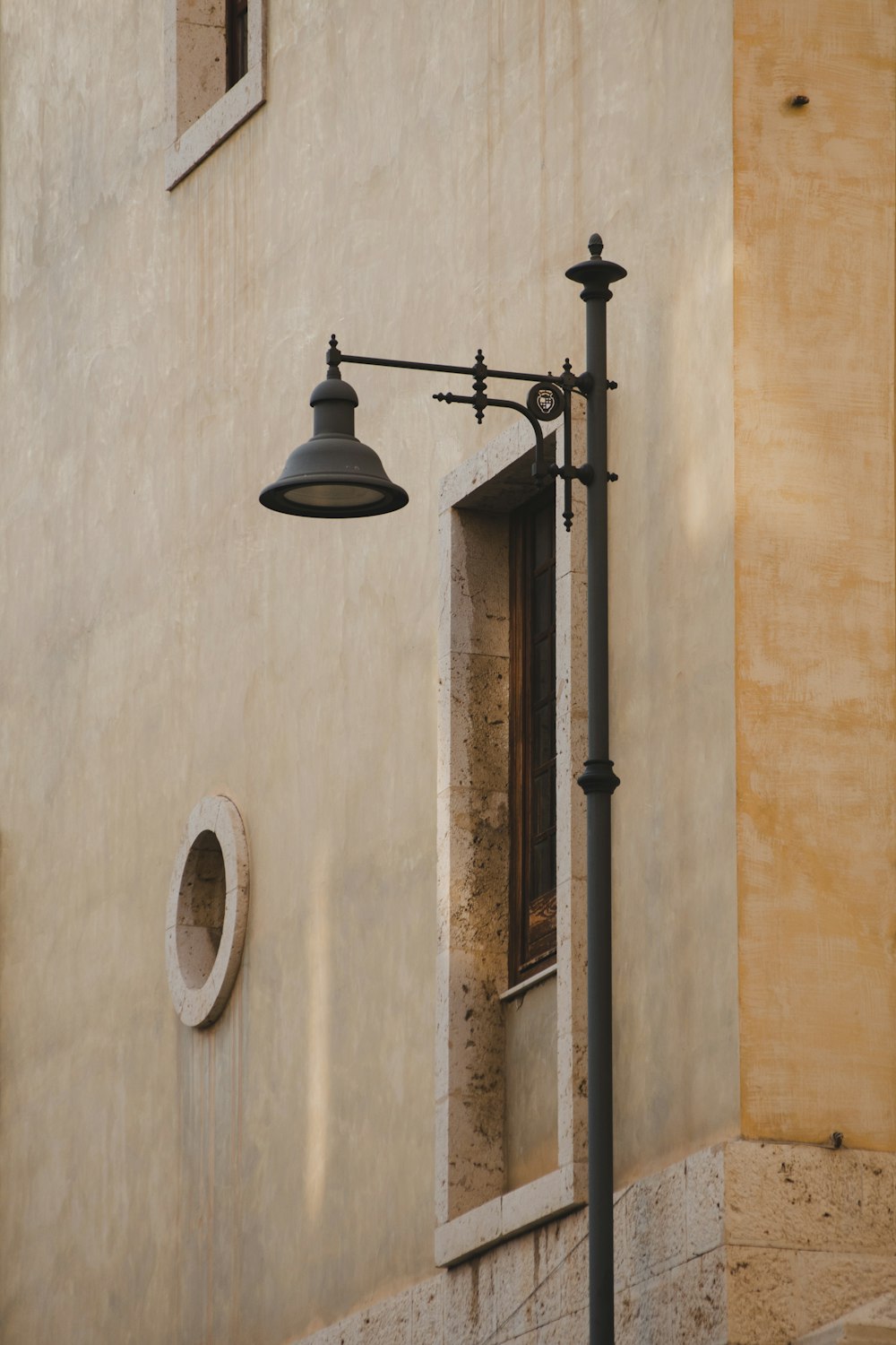 black metal sconce on brown concrete wall