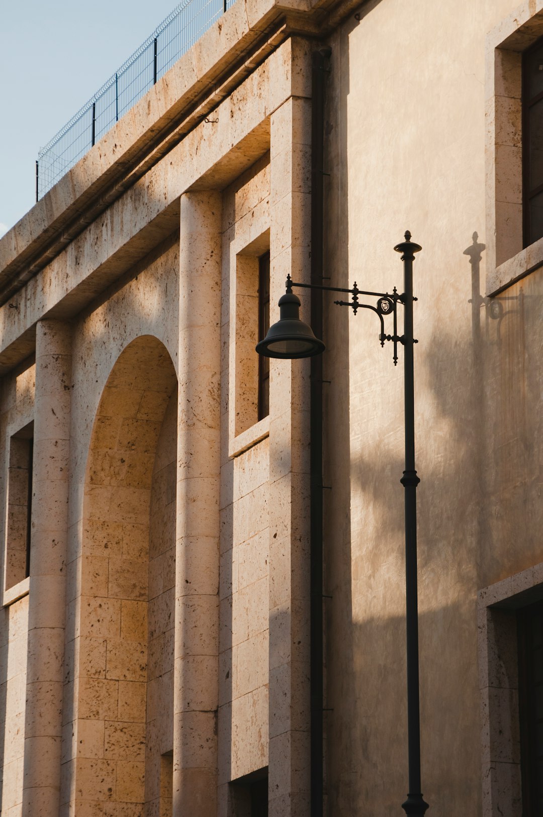 black sconce lamp on brown concrete building