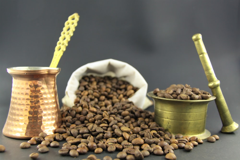 brown coffee beans in green ceramic bowl