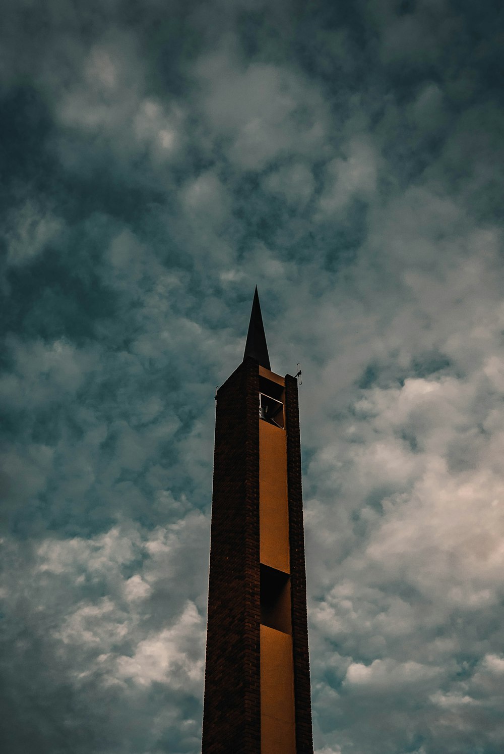 brown concrete tower under cloudy sky during daytime