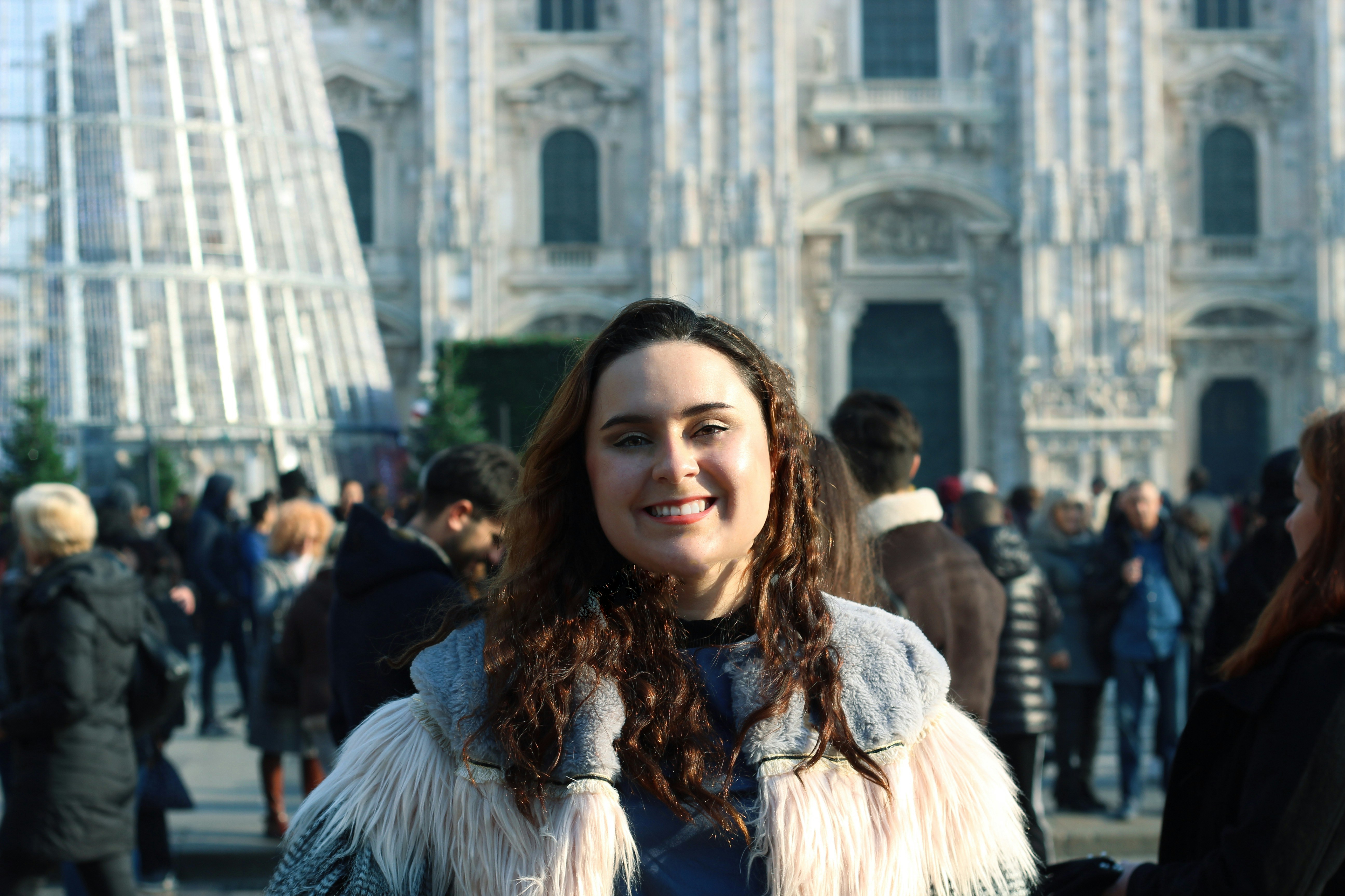 woman in white fur coat smiling