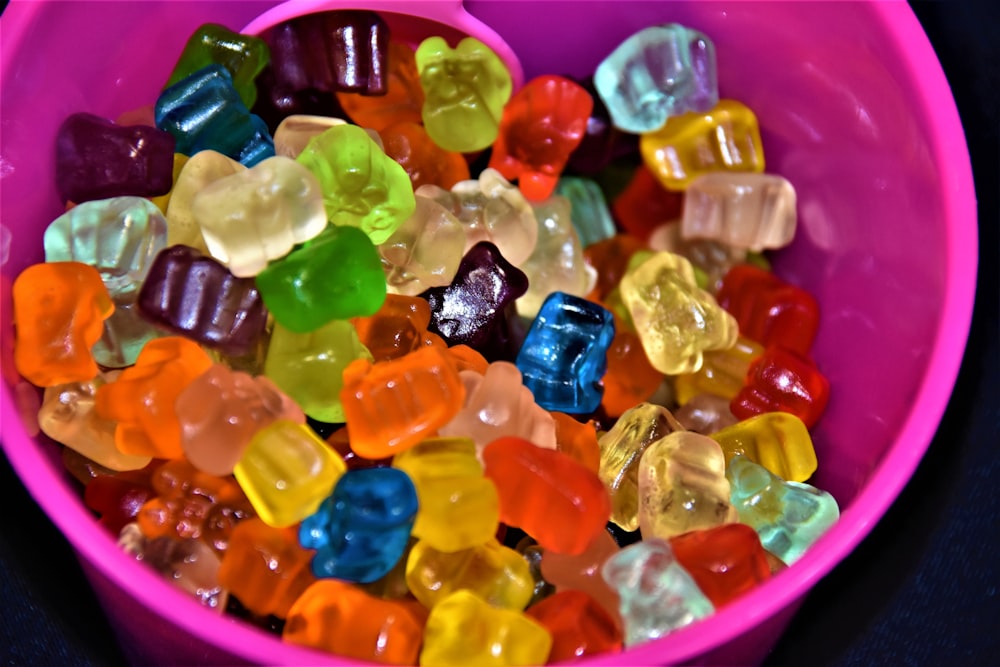 assorted color plastic beads on pink plastic container