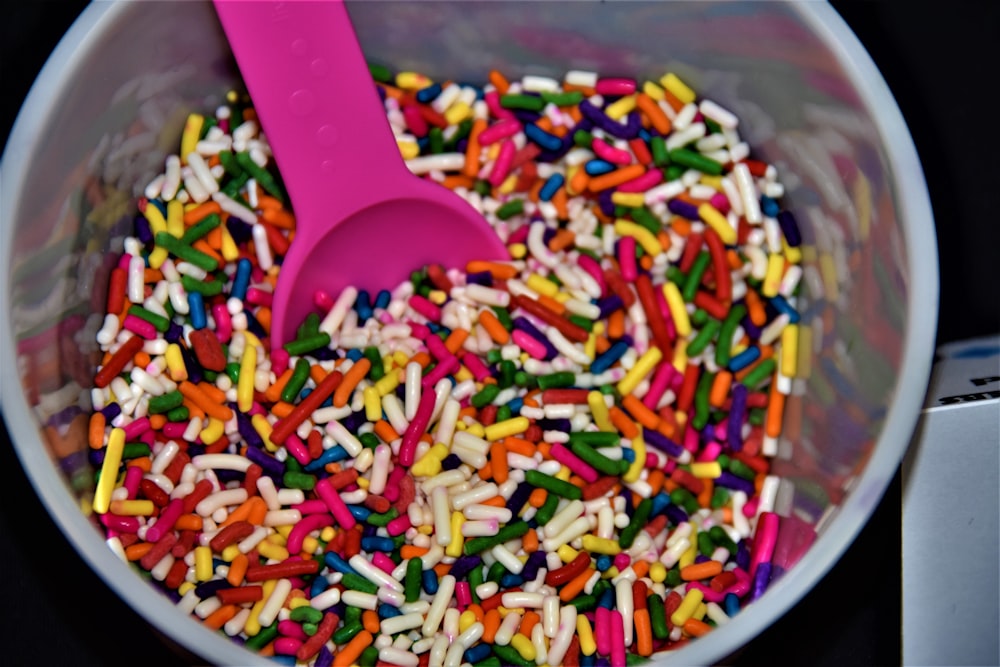 pink plastic spoon on white ceramic bowl