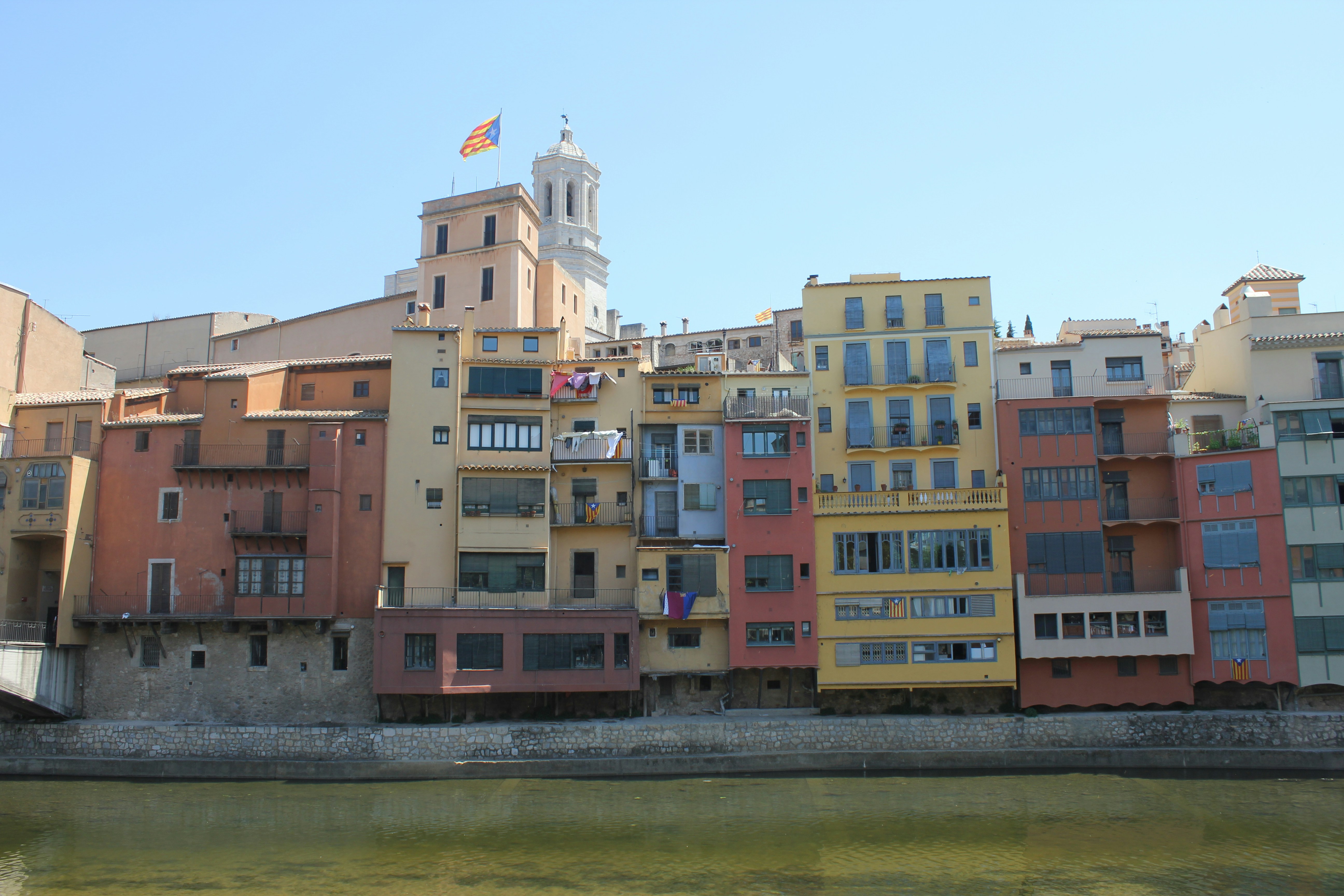 brown and white concrete building near body of water during daytime