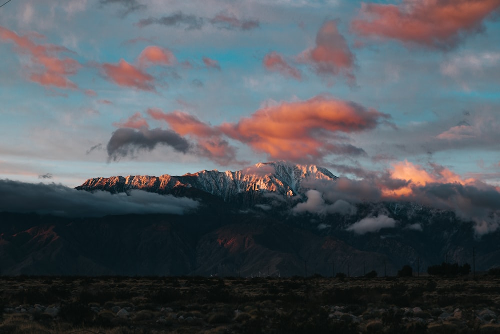 brown and black mountains under white clouds during daytime