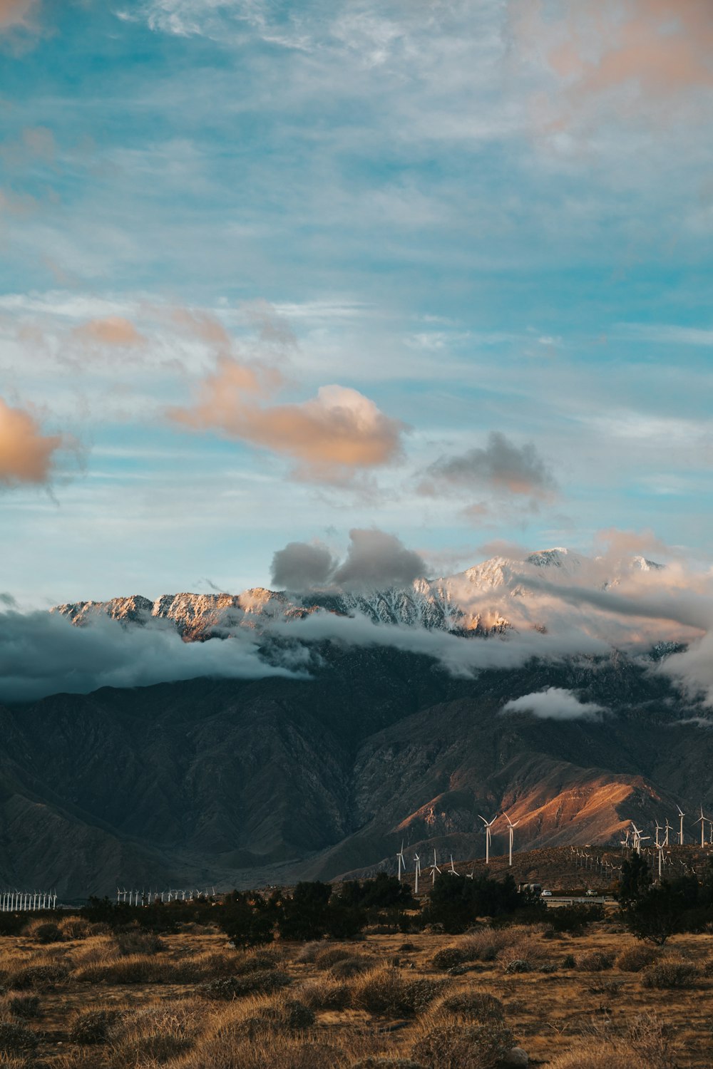 snow covered mountains under cloudy sky during daytime