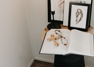 A serene study corner with an open Bible, soft candlelight, and a simple wooden cross.