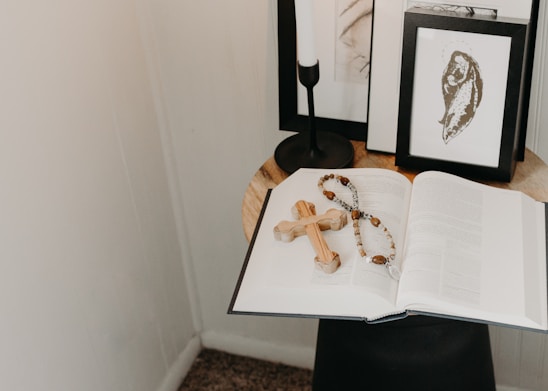 A serene study corner with an open Bible, soft candlelight, and a simple wooden cross.