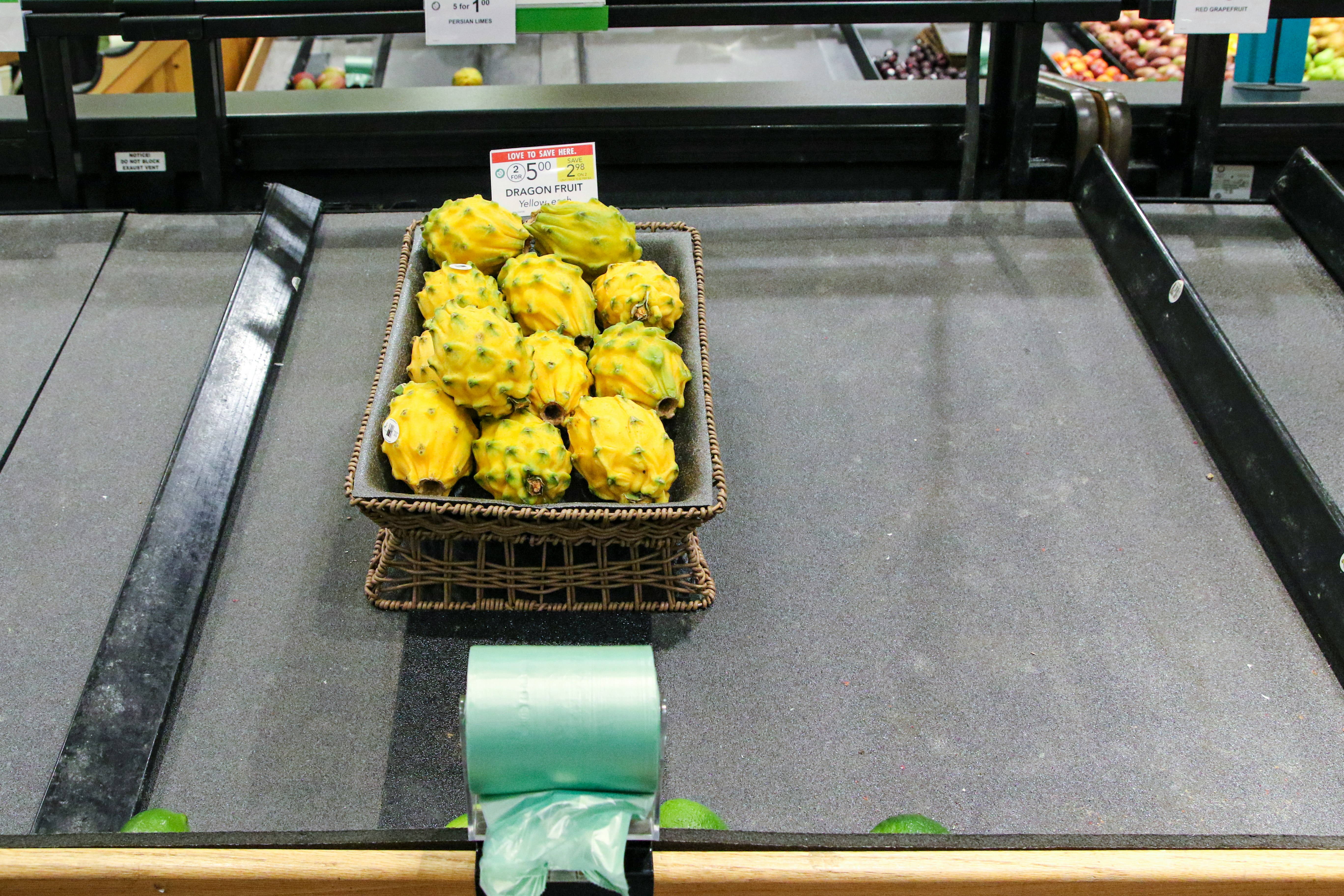 yellow fruits in green plastic crate