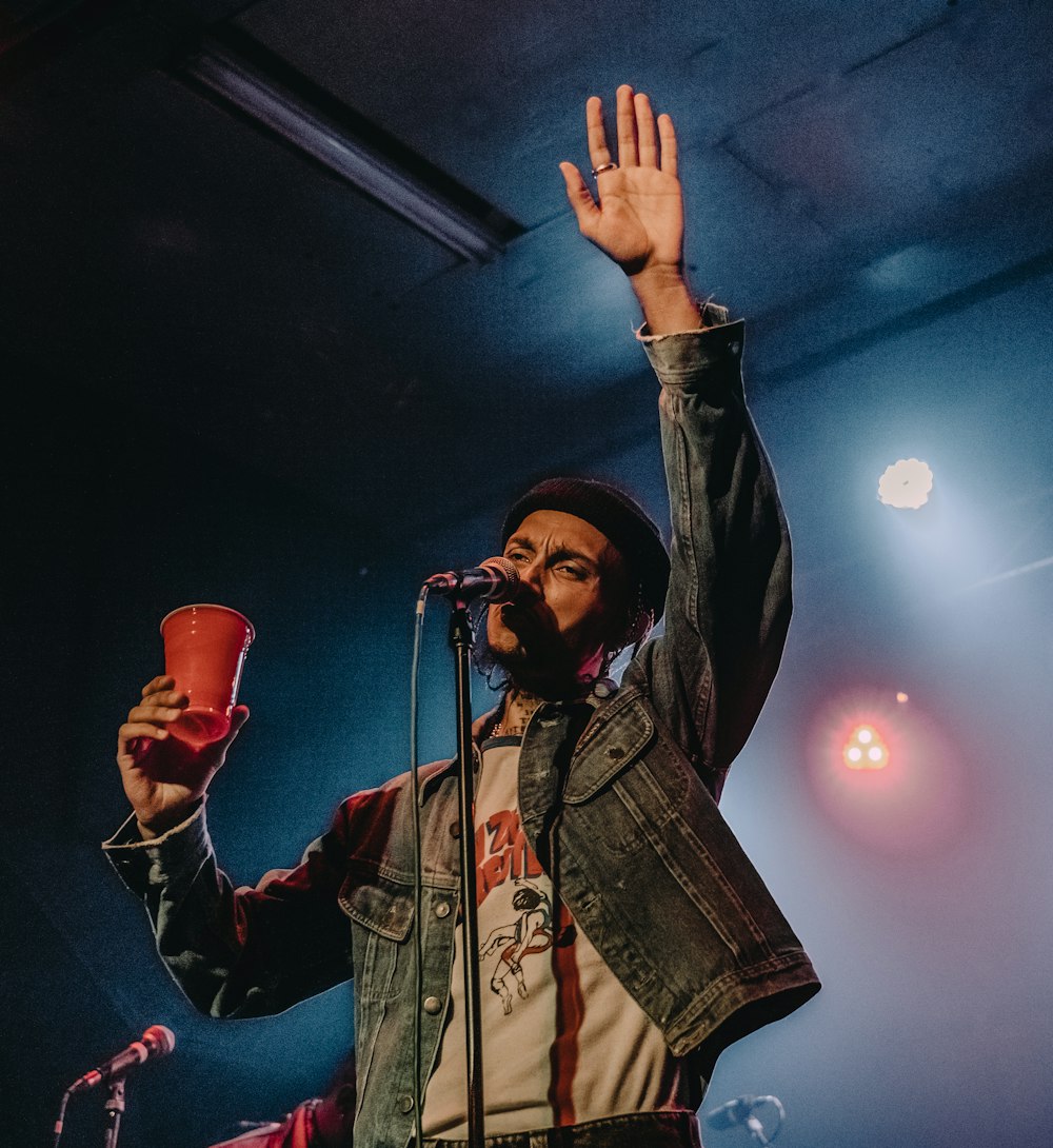 man in black leather jacket singing