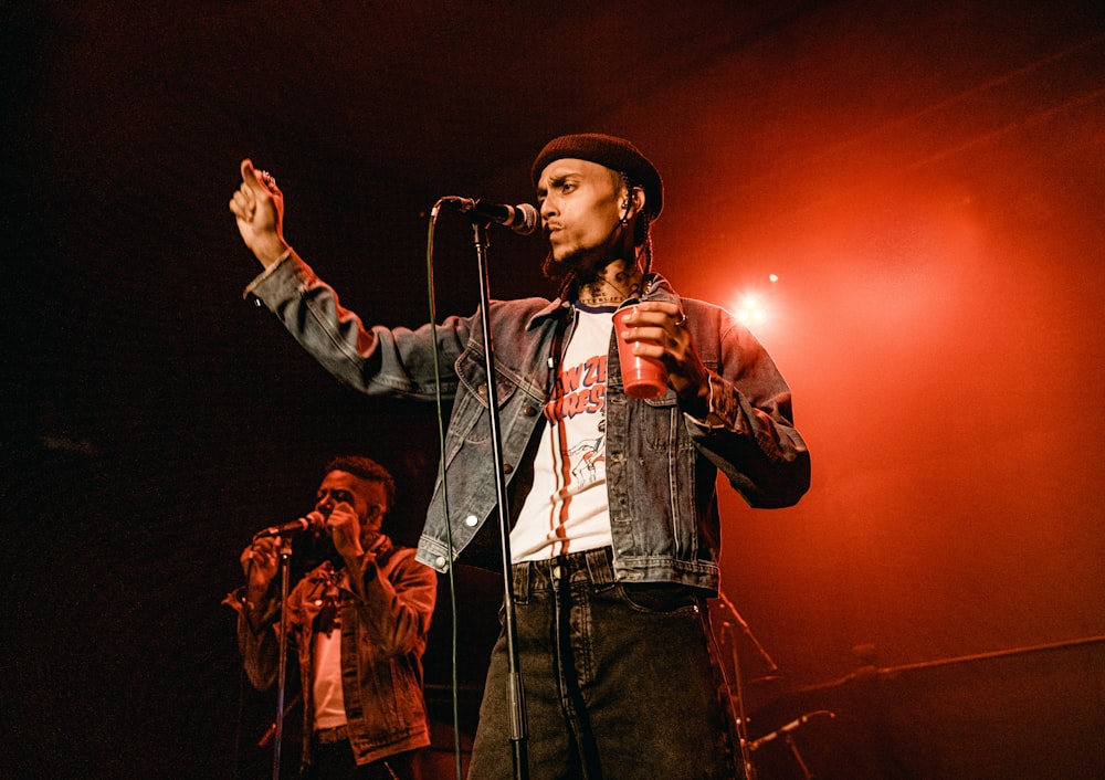 man in black hat singing