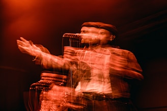 A dynamic performance image featuring the artist in decent man gear.