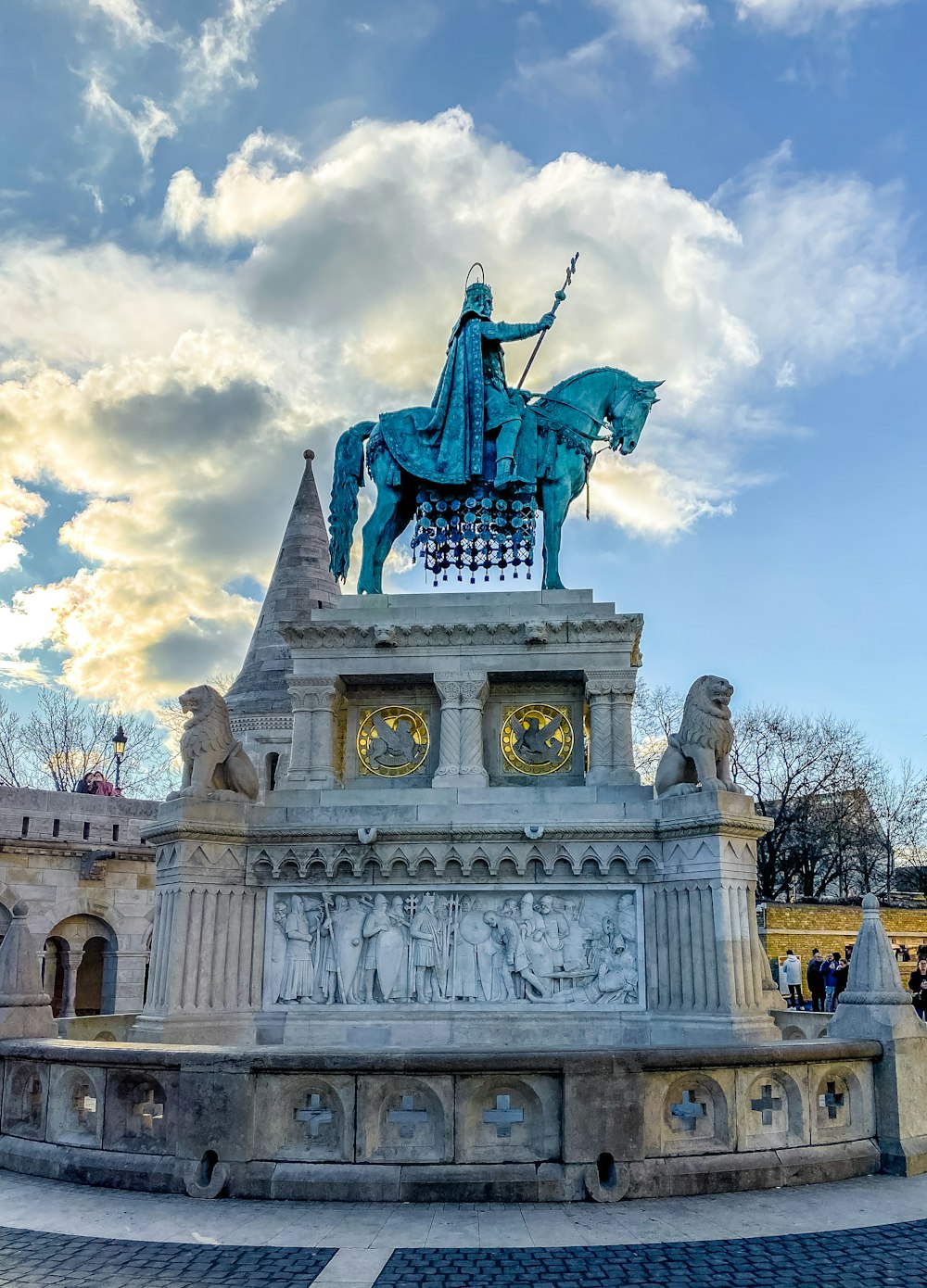 man riding horse statue under cloudy sky during daytime