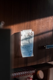 A close-up of a handwritten note on a rustic wooden table.
