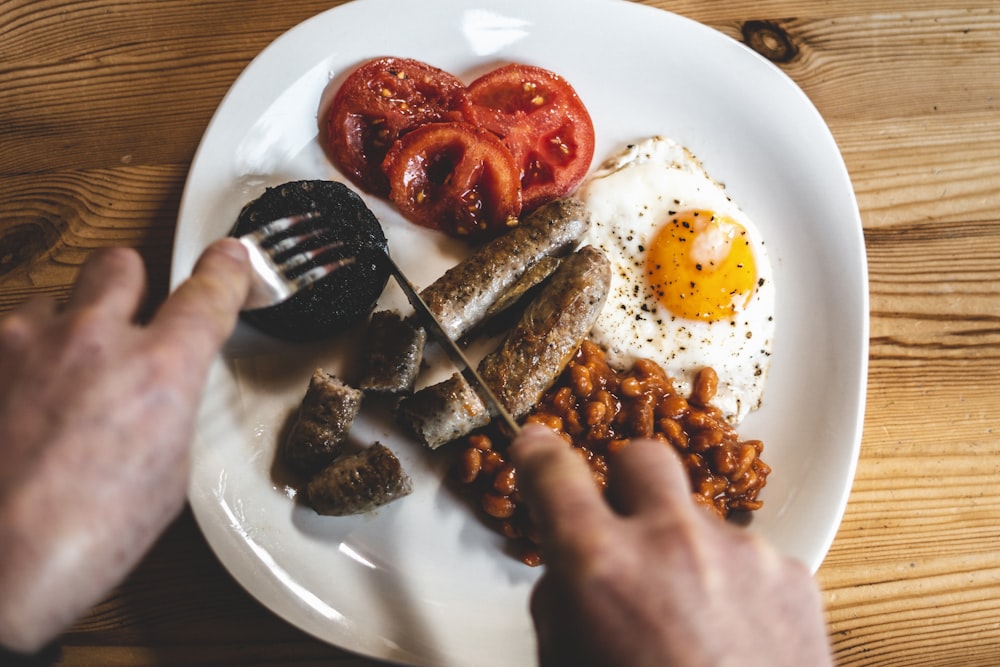 fried egg and fried meat on white ceramic plate