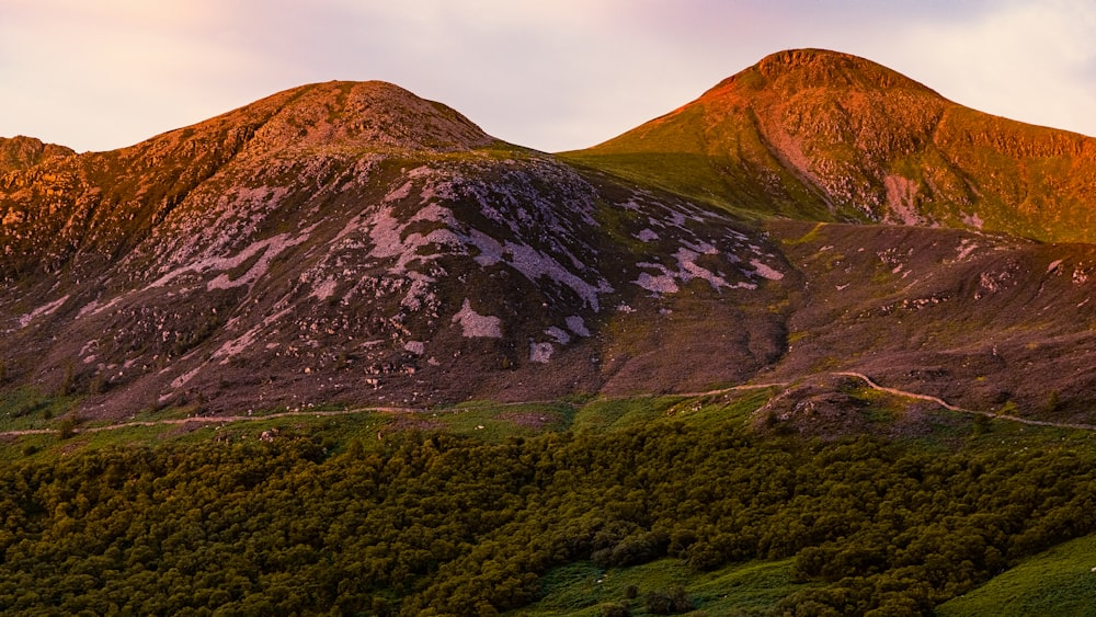 green and brown mountain under white sky during daytime