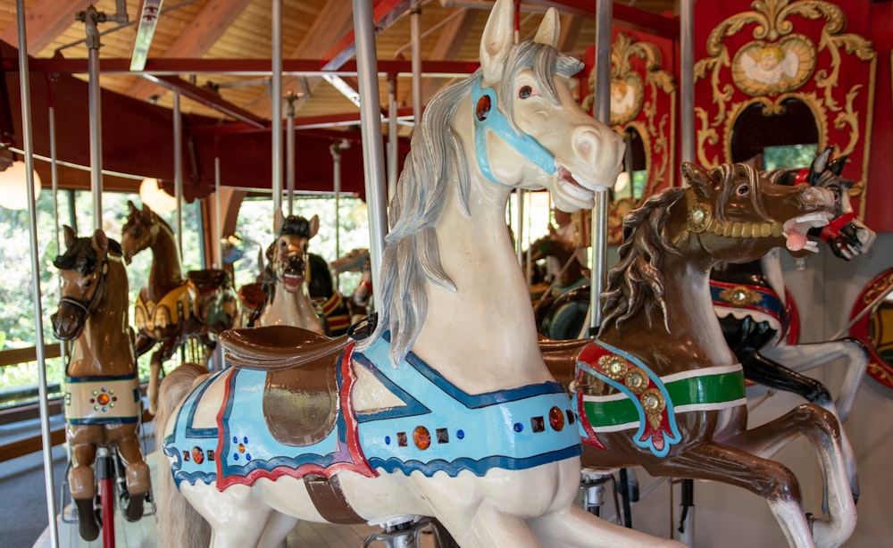 white horse carousel with people