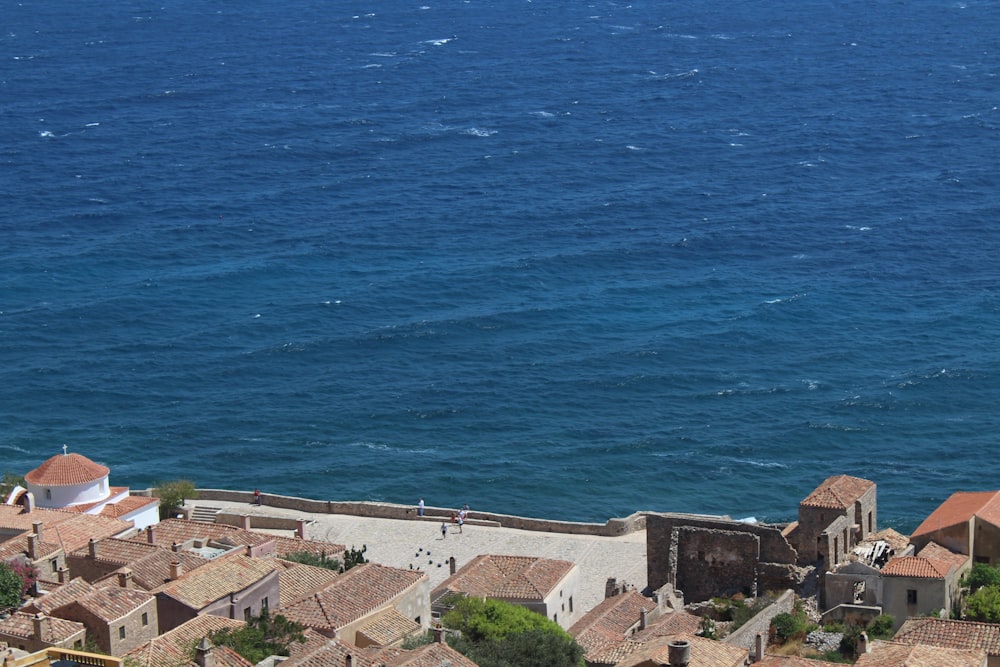 aerial view of houses near sea during daytime